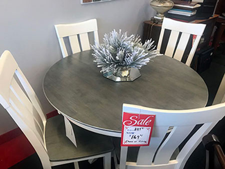 grey circular table with white chairs